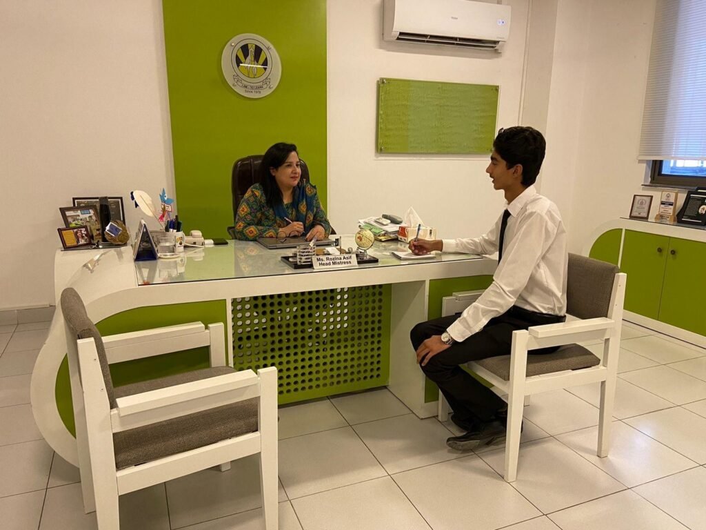 The researcher conducts an interview with Ms. Rozina at her office